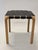 Artek Y61 stool, birch with original black leather upholstery. The stool is from the 1950s. Designer Alvar Aalto. In good...