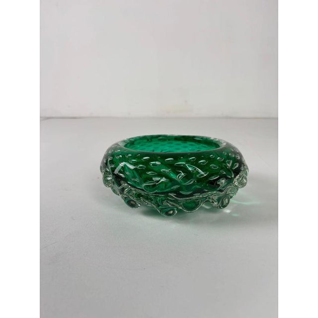 Emerald green Murano glass bowl/ashtray featuring the refined bullicante technique, with delicate air bubbles suspended...