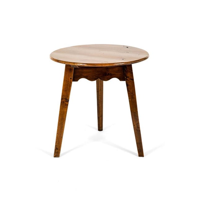 A beautiful 19th century cricket table with a generous thick pine top and a fruit wood base. Beneath a symmetrical cupids...