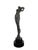 A wonderful bronze figural sculpture on tiered black marble base depicting a woman brushing her hair by noted American...