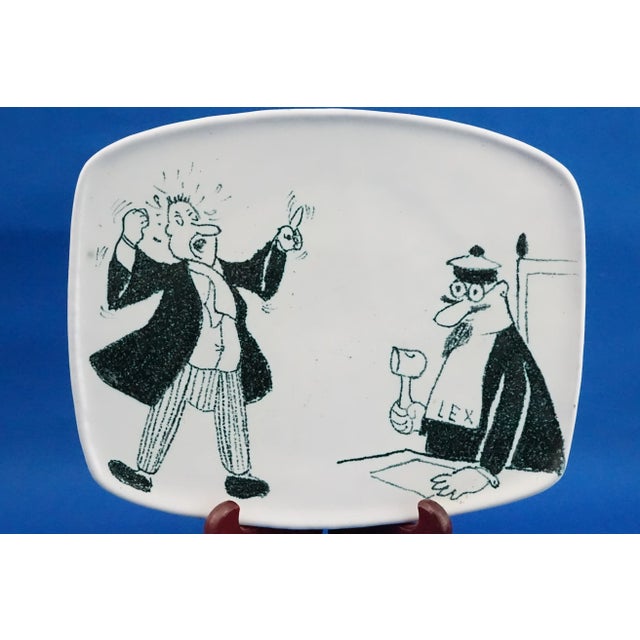 Description of the item: Glazed majolica ceramic plate, decorated with an airbrush and vitrified, with a satirical cartoon...