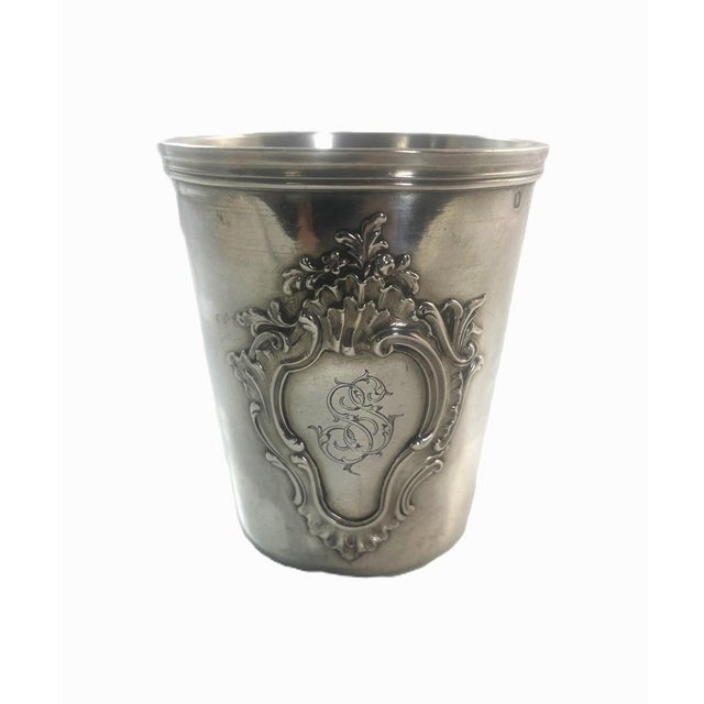 A fine French silver timbale with a central cartouche and applied rocaille motifs. The timbale or beaker has been engraved...