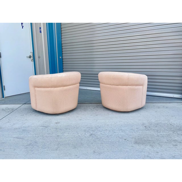 Mid-century swivel lounge chairs were designed and manufactured in the United States circa 1960s. These vintage swivel...