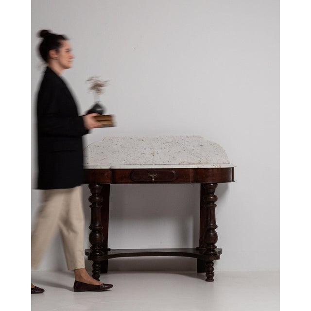 A stone-top piece whose white/gray marble gives it real character at first glance. The piece dates to 19th Century,...