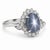 This ring features a blue star sapphire cabochon centerpiece, set in platinum. The star sapphire weighs 7.37 carats. It is...