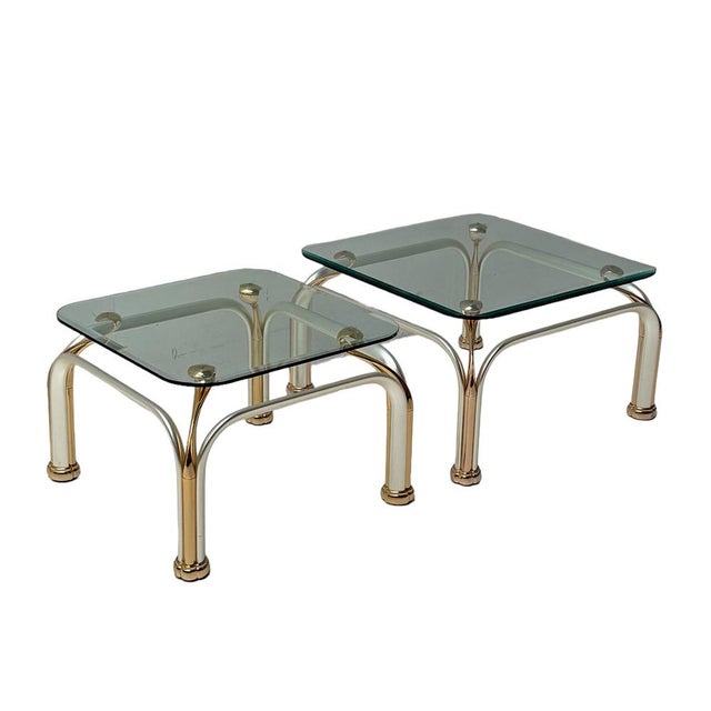 Stunning and elegant set of two Hollywood Regency side tables. Striking Italian design from the 1980s. Partly gilt metal...