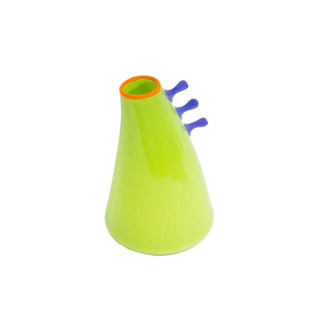 A signed art glass vase by the American artist Jen Violette. This colorful cone-shaped vase has a bright green body with...