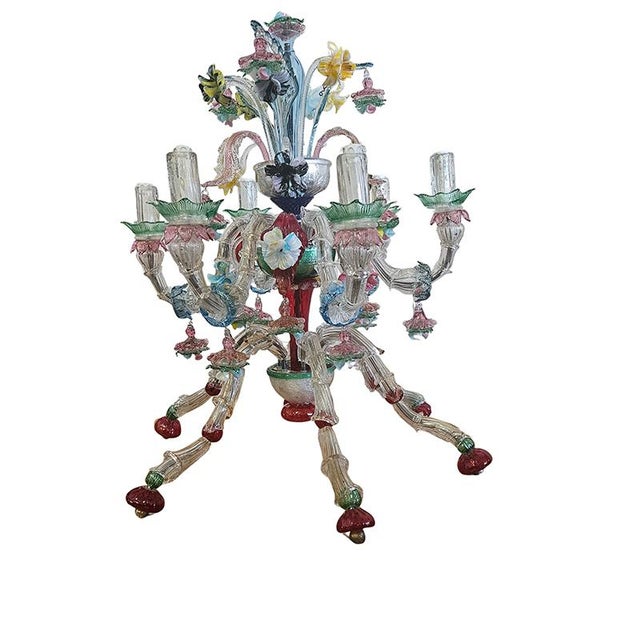 Murano glass table lamp on four legs, featuring six lights, embellished with colorful Murano glass flowers and leaves....