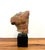 A sculptural study of the male form by Alva, signed and dated 1991. This abstract torso features a textured, earth-toned...