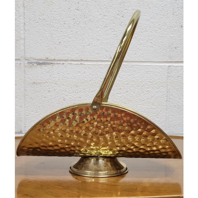 This is a large vintage hammered brass fireplace log holder with adjustable handle and pedestal foot. Made in Holland in...