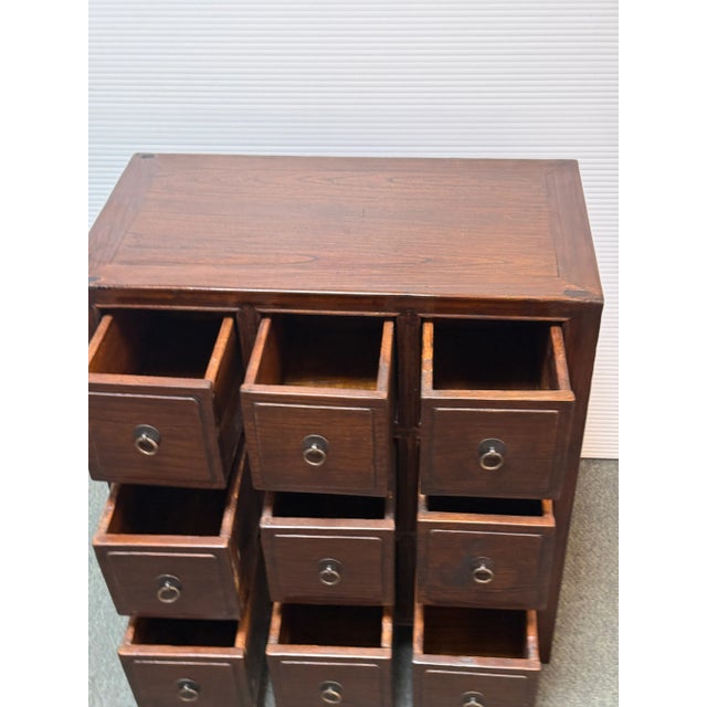 Design Plus Gallery presents a Vintage Chinese Apothecary Chest. Classic nine-drawer storage, the cabinet is handcrafted...