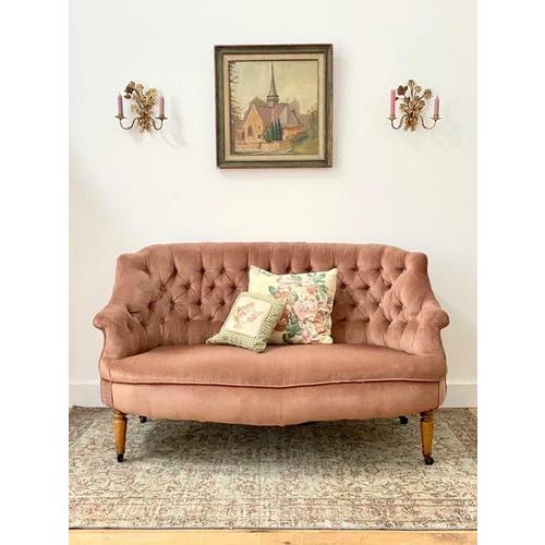 An elegant early 20th century wingback sofa. On lovely turned legs with original castors, it’s ever so pretty in pink....