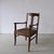 Pair of Biedermeier style armchairs in satin birch with brown upholstered seats. The chairs feature open backs, curved...