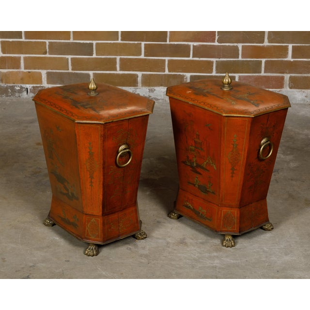 A pair of English Victorian period red lacquered tôle cellarettes from the 19th century with gilded Chinoiserie décor and...