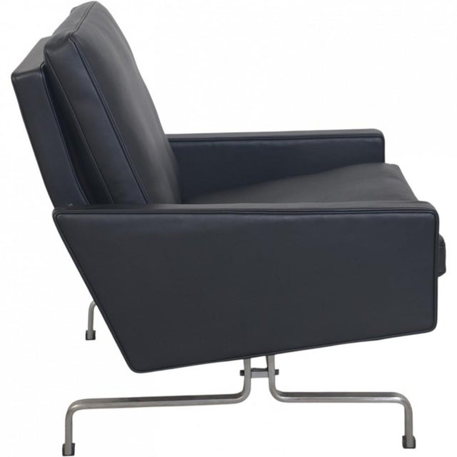 Poul kjærholm pk31/1 armchair upholstered in black anilin leather, and with a frame of chrome spring steel. The chair is...
