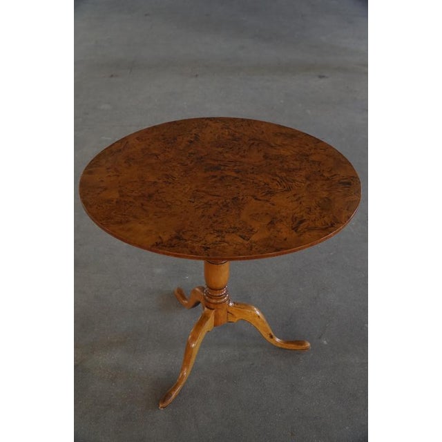A charming Antique Swedish tilt-top table crafted in richly figured burl wood / root veneer, dating to the early 19th...