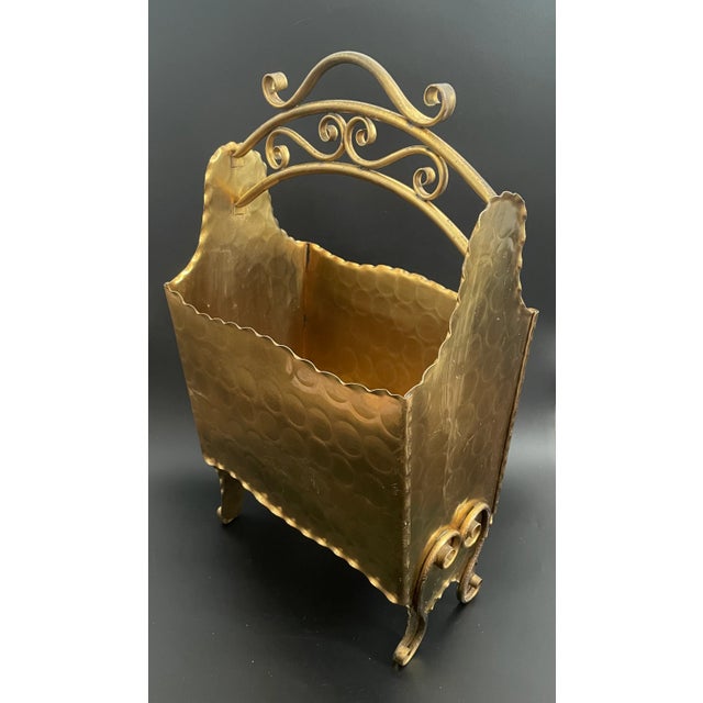 Presenting a Mid Century Gregorian Copper magazine rack. Crafted through the art of hand-beating and adorned with a...