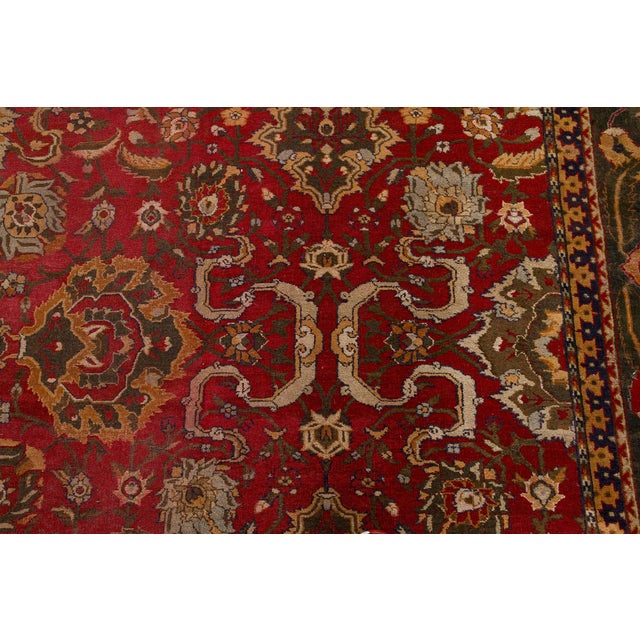 A vibrant example from our collection of early 20th century Indian Agra antique carpets, the rich tomato red field with a...