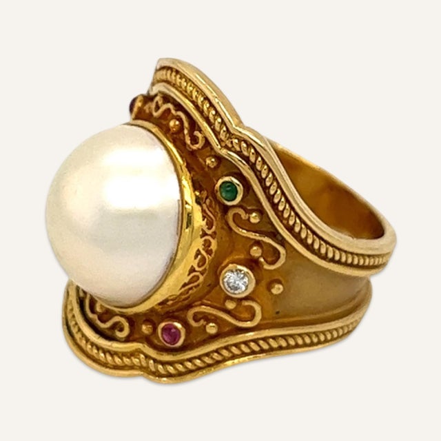 This is part of Chairish’s Fine Jewelry assortment. Pearl, diamond, ruby and emerald ring in the style of Elizabeth Gage,...