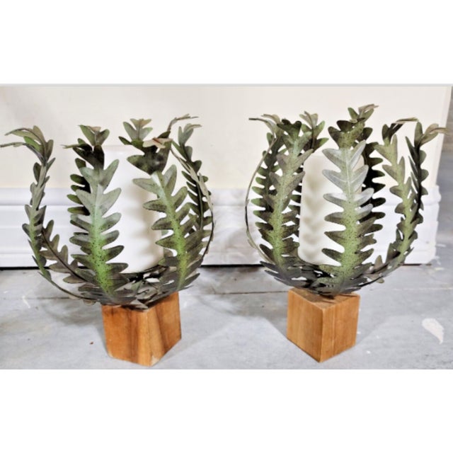 This is a very nice pair of candle holders, each on a wooden base with a metal fern in the classic Italian toleware style...