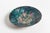 This hand-hammered copper bowl shows a motif with four -presumably- female heads and is executed in the typical style of...