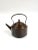 A light weight copper tea kettle with a handle.