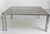 French coffee table with glass top and chrome structure. This design with it double legs is typical of the 1970's. In good...