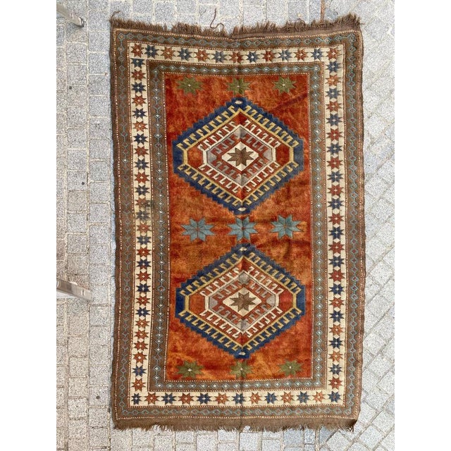 Exquisite vintage Turkish rug from the Kars region, dating back to the mid-20th century. This handmade masterpiece...
