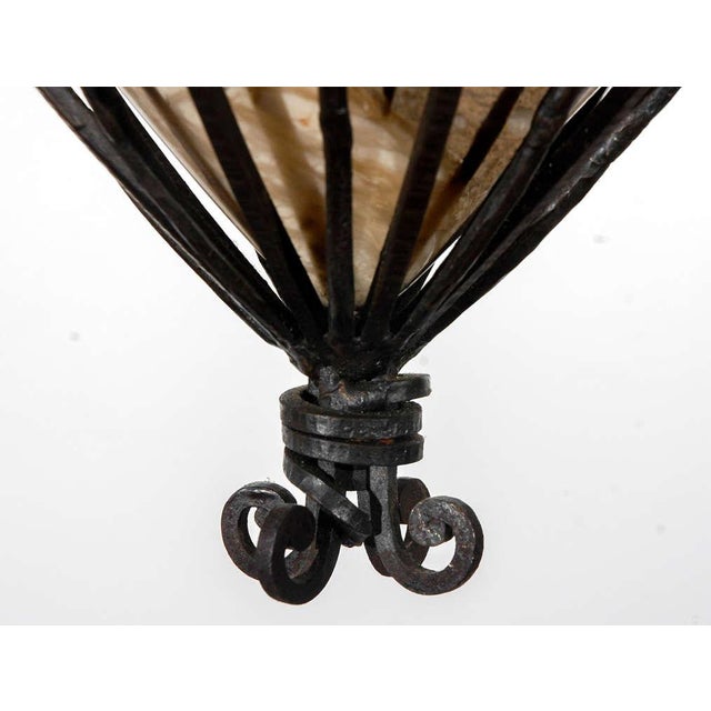 Finely wrought iron and alabaster fixture featuring flowers, leaves, and pods. Four lights, newly wired.