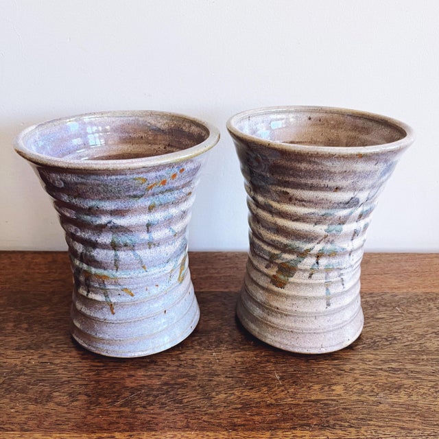 Vintage pair of studio pottery ribbed vases with a blue glaze with leaf motifs. Signed by artist and dated ‘99. This...