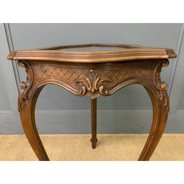 A charming late 19th century French bijouterie table. Well constructed in solid walnut and decorated with crisply carved...