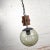 Handsome mid-century modern NOS (new old stock) slightly brutalist or rustic black, wood, and smoked glass globe pendant...