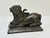 Stately, recumbent heavy Borghese lion sculpture with curled tail upwards and magnificent mane. In good condition - some...