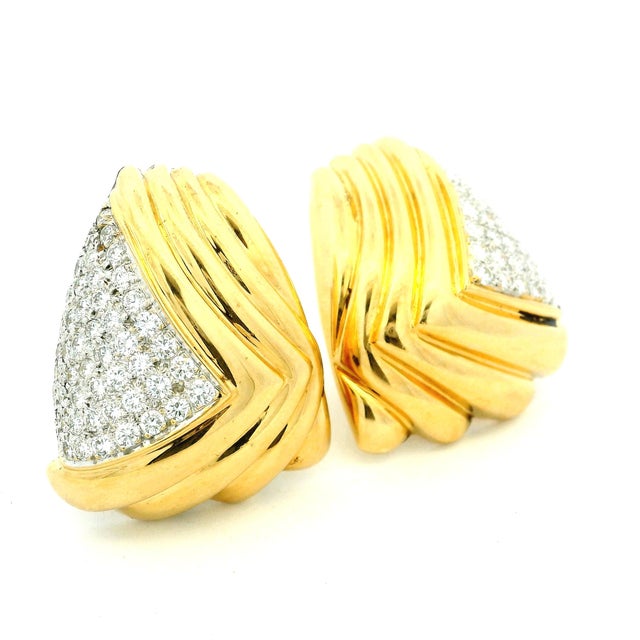 Bold vintage Italian ear clips dating to circa 1980, crafted in substantial 18K yellow gold and accented with...