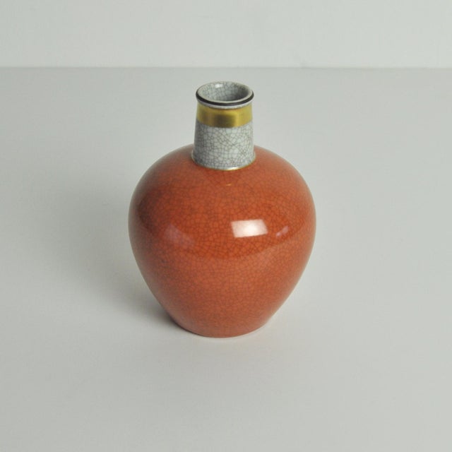 Elegant Royal Copenhagen crackle glazed vase. Orange-brown on grey crackle glaze with gilded bands. Pale grey crackle...