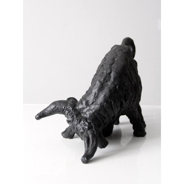 This vintage cast iron bull statue features a bold, sculptural form that adds strength and character to any space. Its...