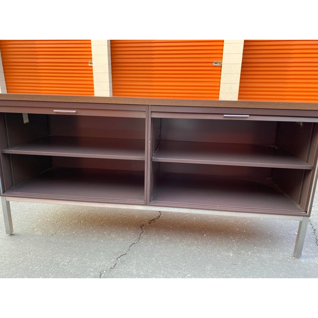 The Steelcase Vintage Mid Century Modern Metal Retro Tanker Credenza Sideboard is a stylish and unique piece of furniture...