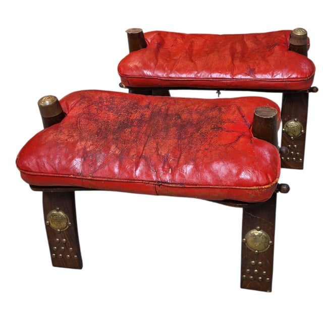 1950s Moroccan Camel Stools in Red Leather that are now perfect foitstools. Originally used as camel saddles, they became...