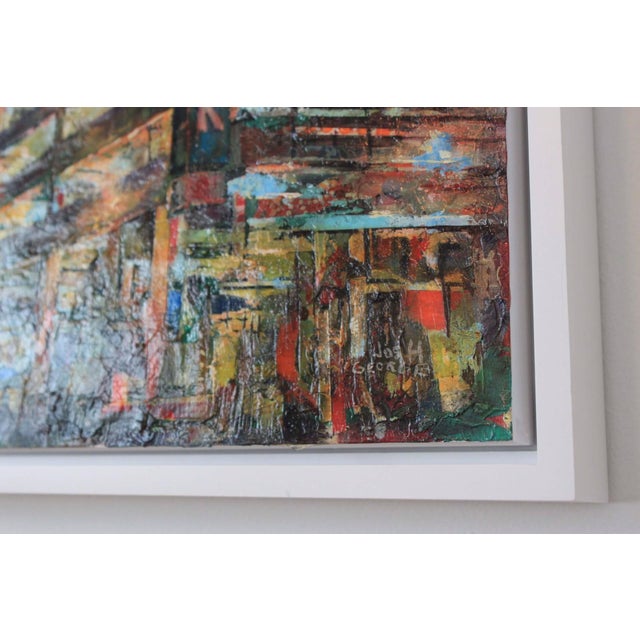 This mixed media artwork depicts a vibrant urban scene, showcasing a parking structure against a backdrop of towering...