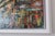 This mixed media artwork depicts a vibrant urban scene, showcasing a parking structure against a backdrop of towering...