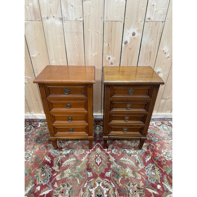 Pair of louis xvi style bedside tables, reproductions from the 1970s-1980s in warm brown stained wood. each piece features...