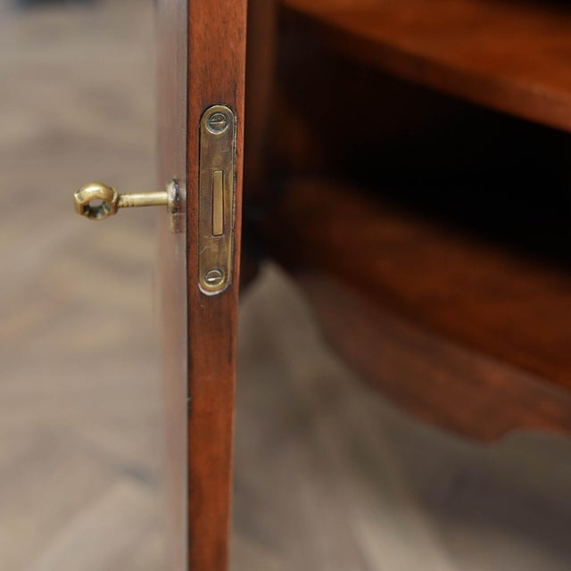 This Vintage John Richard Demi Lune Cabinet, brought to you by Niagara Furniture, was produced by master craftsmen that...