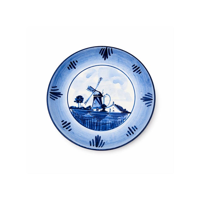 Charming vintage Delft Holland ceramic plate featuring a classic blue and white hand-painted windmill landscape. Marked...