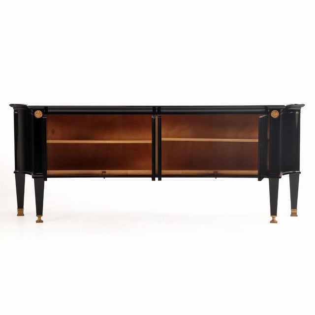 A sculptural French sideboard, circa 1940, executed in ebonized wood with elegant bronze mounts, in the refined...