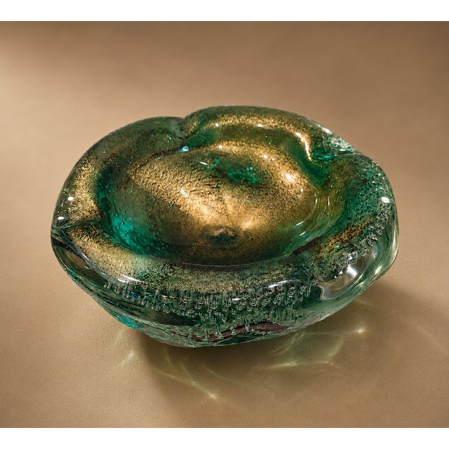 Bring authentic Mid-Century Modern elegance into your home with this stunning vintage Murano-style art glass ashtray,...