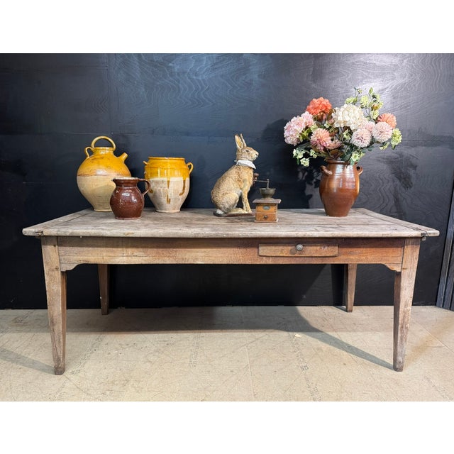 A French Kitchen Dining Table from the region of Normandy. Made from Chestnut and dating to the mid 19th Century. It has a...