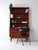 Elegant vintage teak bookcase, with drawers and retractable desk. Essential Scandinavian design, embellished with carved...