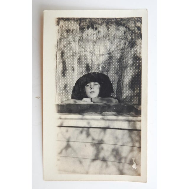 Early 20th century silver gelatin snapshot photograph mood portrait of a young woman. Unframed.