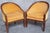 A striking pair of Art Deco barrel-back armchairs featuring an unusual faux tortoiseshell decorative finish and elegant...