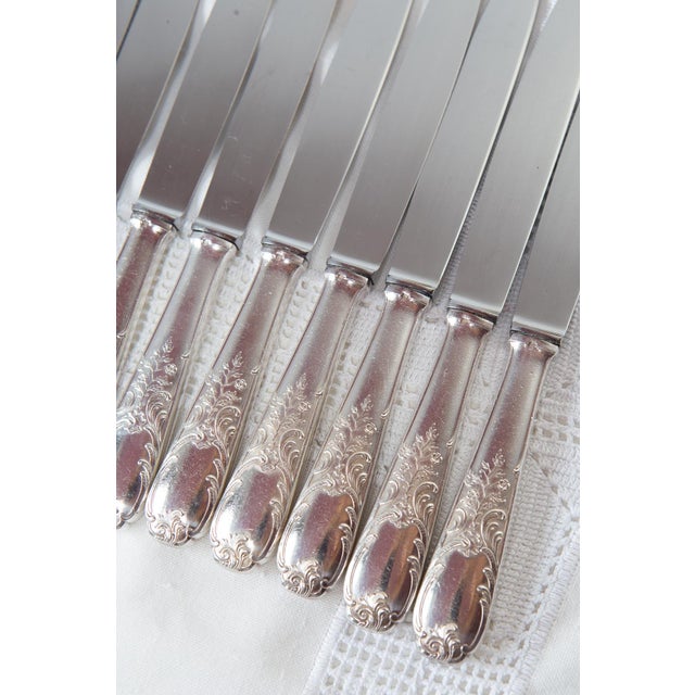 Set of 12 table knives with silver-plated metal handles decorated in Louis XV / Rococo style and stainless steel blades....